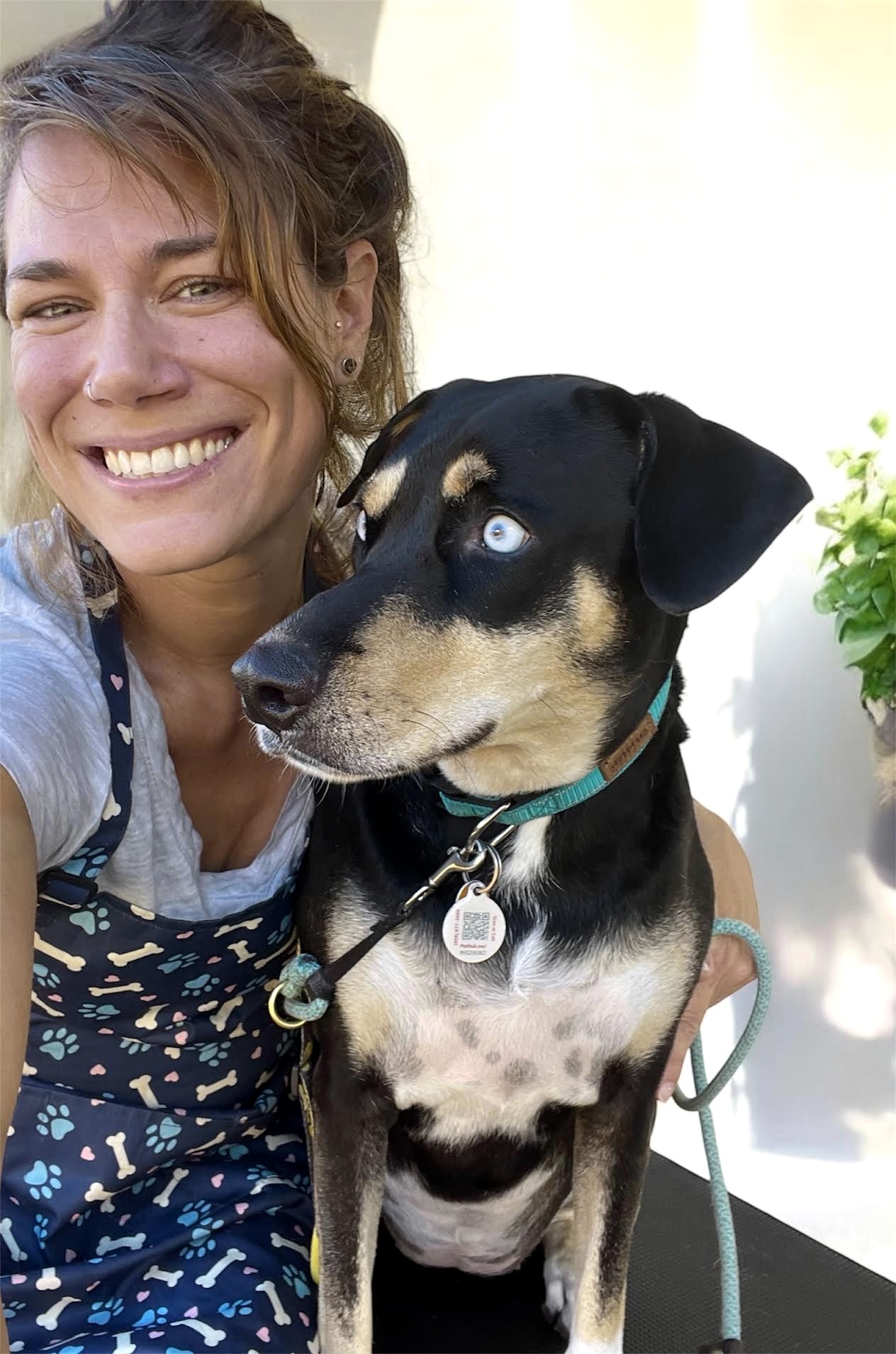 Maui Dogs owner smiling with a dog